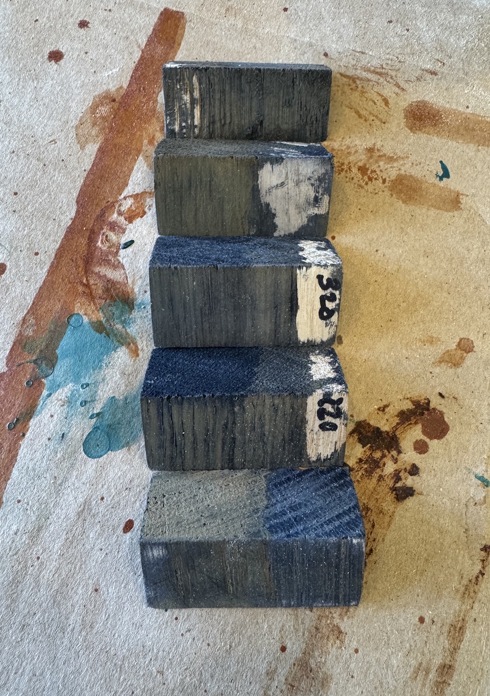 Test pieces from before I tried the bark powder. You can see on the second from the bottom that the end grain is much more consistent and receptive, but on the face grain the color is at best a medium grey. After it sat out for a week it started to turn orange where I had attempted multiple coats, presumably from unreacted rust.